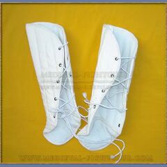 White padded greaves on yellow background
