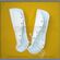 White padded greaves on yellow background