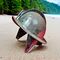 morion helmet on beach with jungle in background